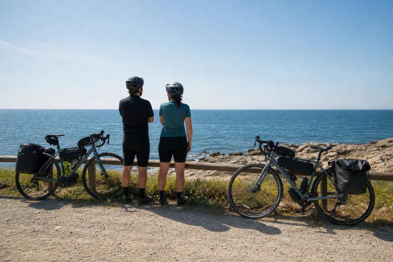 Touring bikes resting beside the sea on the Catalan coast after a day on the greenway from Barcelona